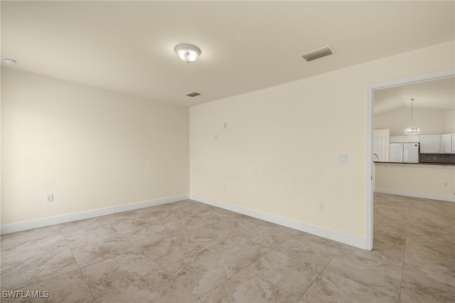 spare room with lofted ceiling