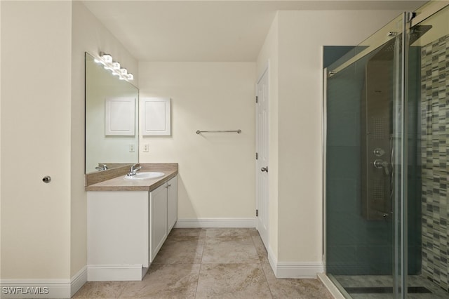 bathroom with an enclosed shower, vanity, and tile patterned floors