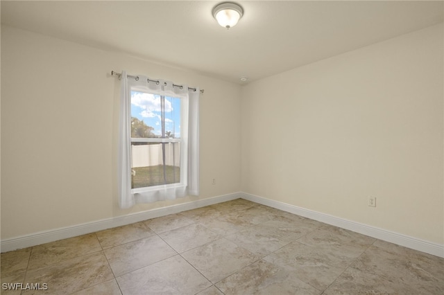 spare room featuring light tile patterned floors