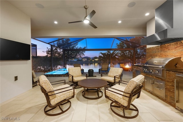 8949 Mustique Ln, Naples, FL 34114 - view of patio / terrace with exterior kitchen, a ceiling fan, glass enclosure, and a water view