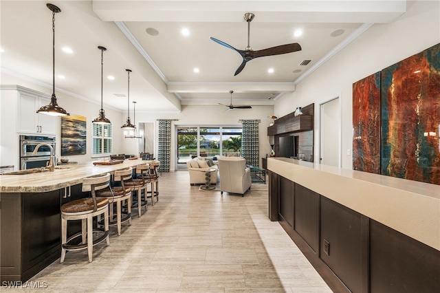 8949 Mustique Ln, Naples, FL 34114 - kitchen with a ceiling fan, a kitchen breakfast bar, ornamental molding, double oven, and recessed lighting