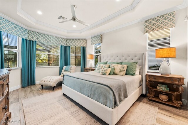 8949 Mustique Ln, Naples, FL 34114 - bedroom featuring crown molding, a tray ceiling, wood finished floors, a ceiling fan, and recessed lighting