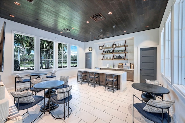 8949 Mustique Ln, Naples, FL 34114 - dining area featuring wood ceiling, light tile patterned flooring, and recessed lighting