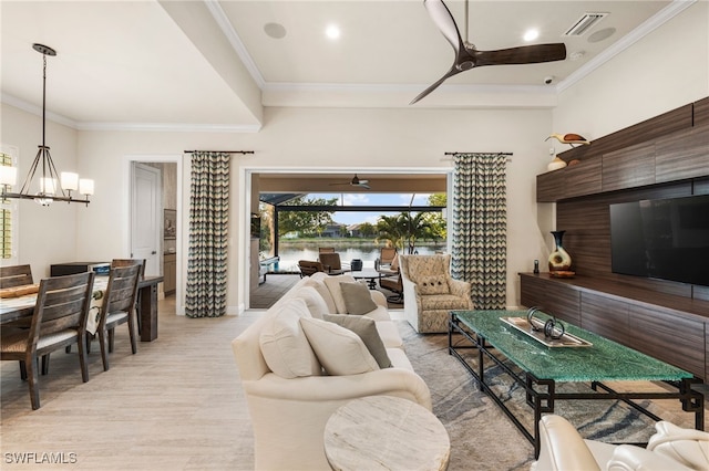 8949 Mustique Ln, Naples, FL 34114 - living area with ceiling fan, a chandelier, light wood-style floors, and ornamental molding