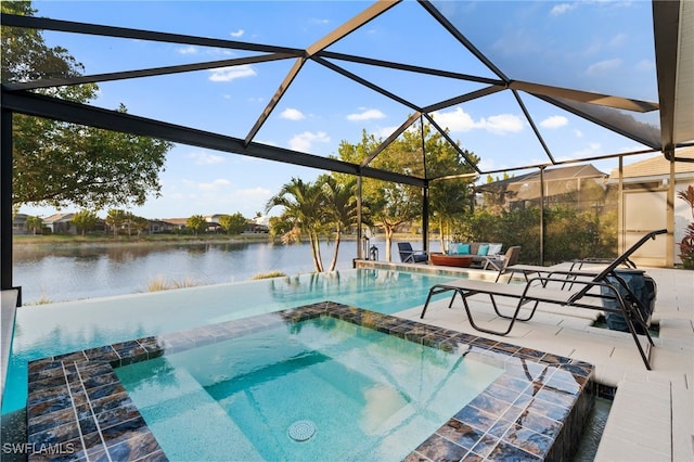 8949 Mustique Ln, Naples, FL 34114 - view of swimming pool with a patio area, a water view, a pool with connected hot tub, and glass enclosure