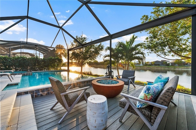 8949 Mustique Ln, Naples, FL 34114 - wooden terrace with a water view, an outdoor pool, a lanai, and an outdoor living space with a fire pit