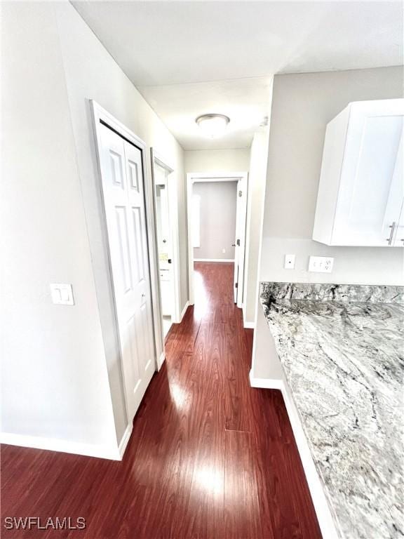 hall with dark hardwood / wood-style flooring