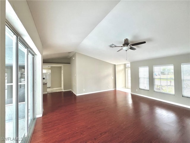 spare room featuring lofted ceiling, dark hardwood / wood-style floors, and ceiling fan