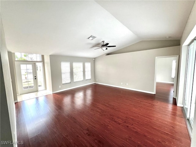 unfurnished living room with dark wood-type flooring, ceiling fan, and vaulted ceiling