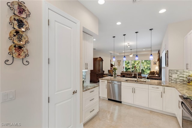 kitchen with kitchen peninsula, decorative light fixtures, sink, dishwasher, and white cabinets