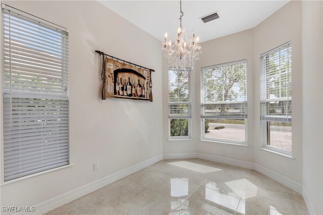 unfurnished dining area featuring light tile patterned flooring, visible vents, baseboards, and a notable chandelier