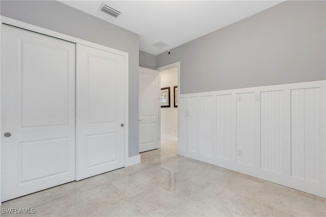 unfurnished bedroom featuring a closet and visible vents