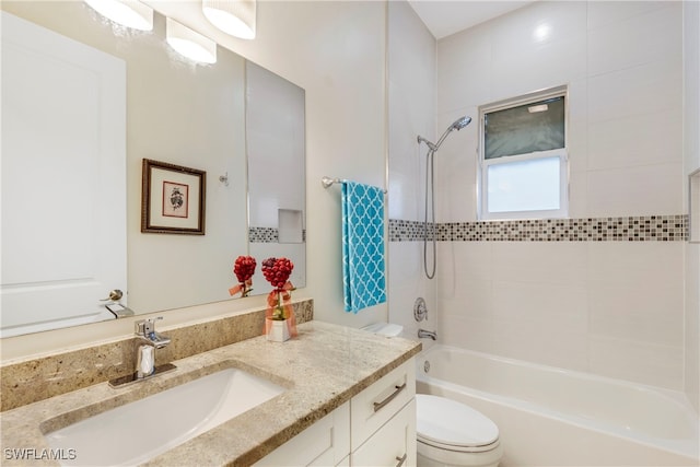 full bathroom with tiled shower / bath combo, vanity, and toilet