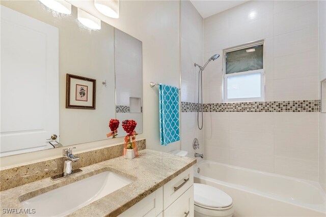 bathroom with toilet, vanity, and washtub / shower combination
