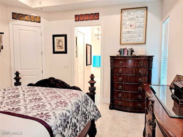 bedroom featuring an inviting chandelier and light tile patterned flooring