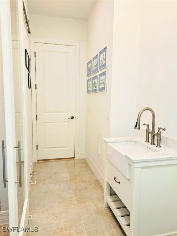 bathroom featuring baseboards and vanity