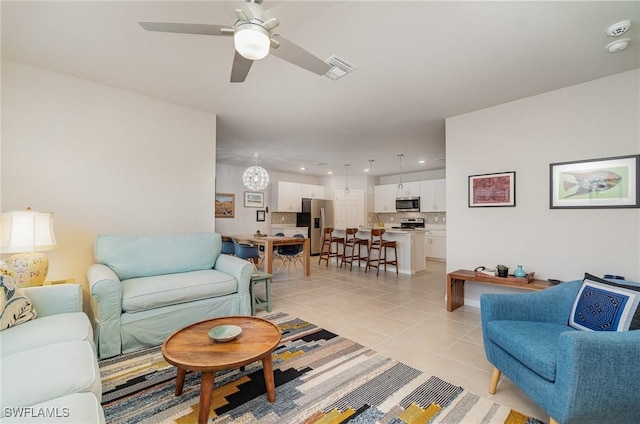 living room featuring ceiling fan and light tile patterned flooring