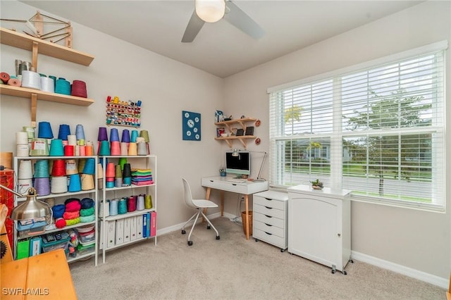 home office with light carpet and ceiling fan