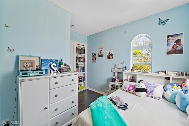 bedroom with dark wood-type flooring