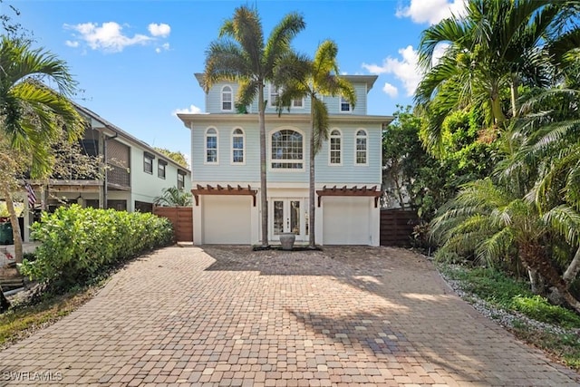 view of front of house with a garage and french doors