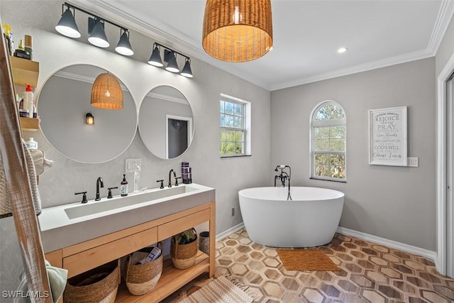bathroom with crown molding, vanity, and a bathtub