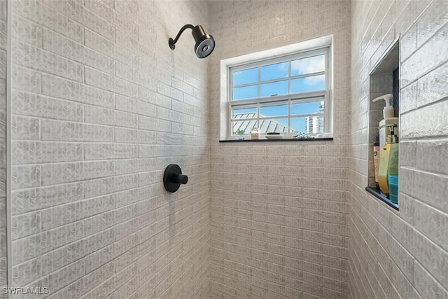 bathroom with a tile shower