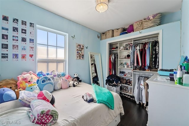 bedroom with wood-type flooring and a closet