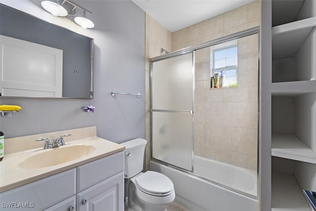 full bathroom with vanity, combined bath / shower with glass door, and toilet
