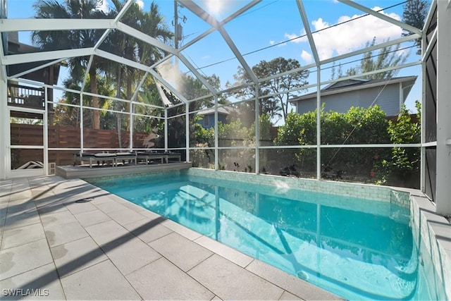 view of swimming pool with a lanai and a patio area