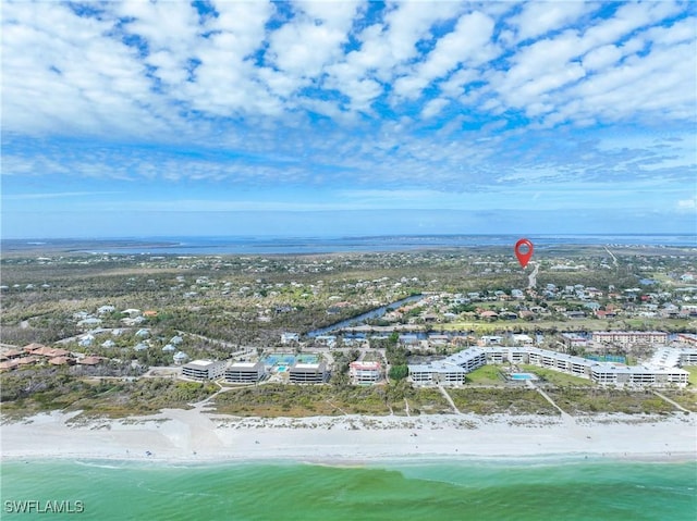 drone / aerial view featuring a water view and a view of the beach