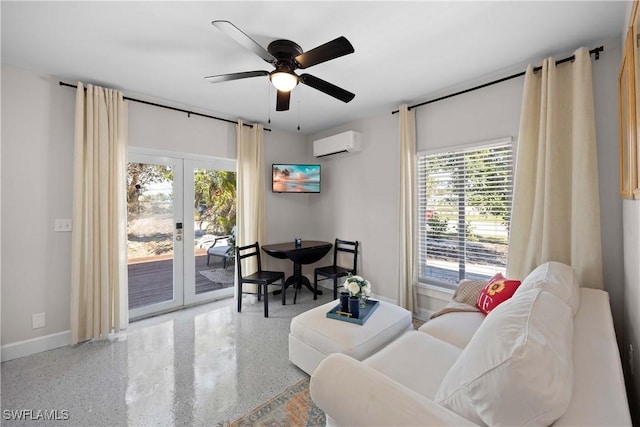 living room featuring ceiling fan, a wall unit AC, and french doors