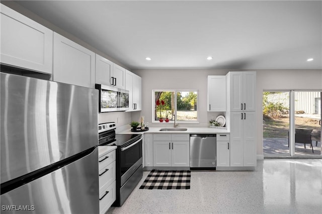 kitchen with white cabinetry, sink, and appliances with stainless steel finishes