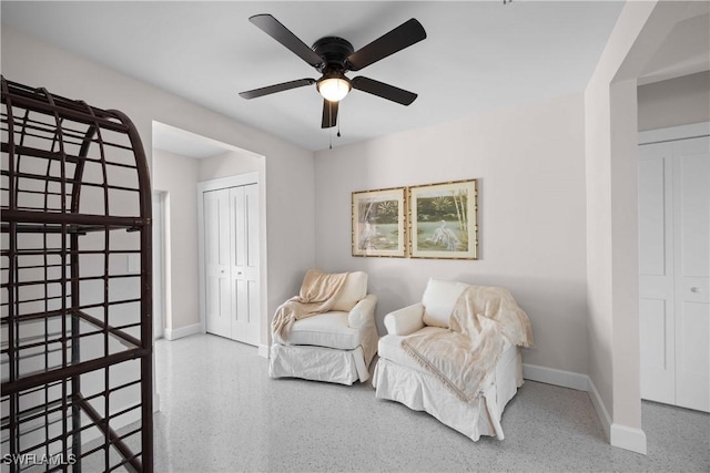 sitting room featuring ceiling fan