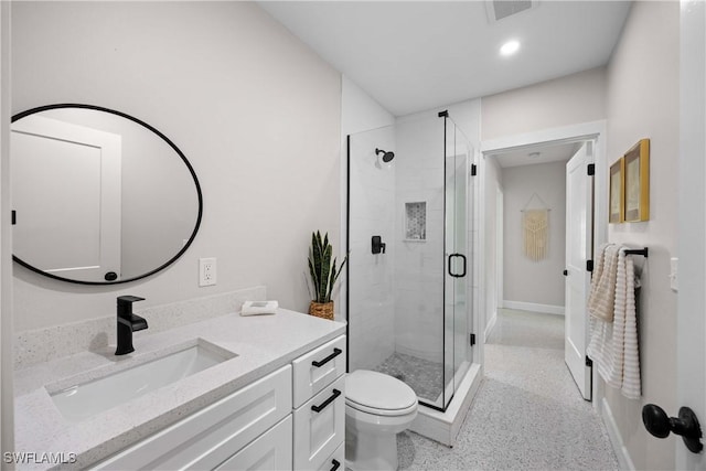 bathroom featuring vanity, toilet, and a shower with shower door