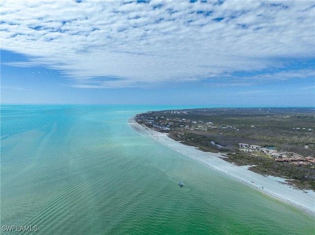 drone / aerial view featuring a water view and a beach view