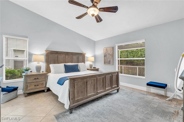 bedroom with lofted ceiling, light tile patterned floors, and ceiling fan