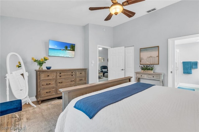 bedroom with lofted ceiling, visible vents, ceiling fan, and baseboards