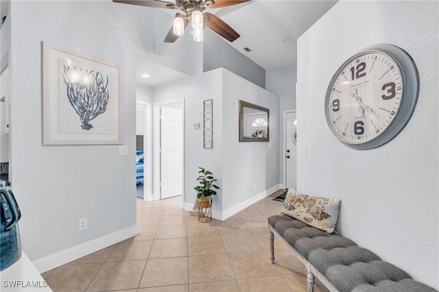 interior space with light tile patterned floors, ceiling fan, visible vents, and baseboards