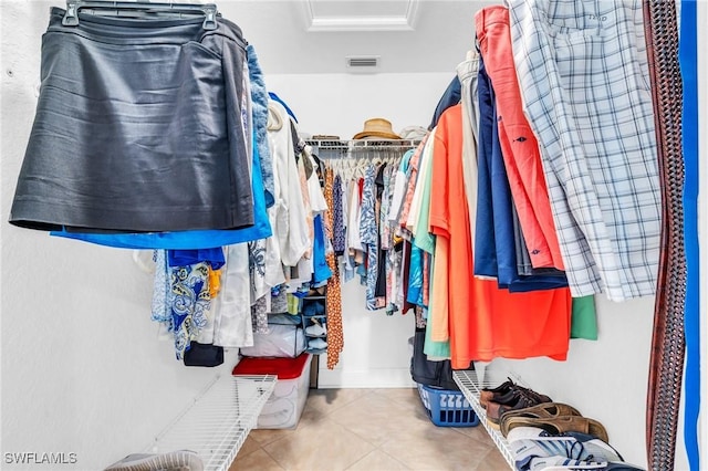 spacious closet featuring visible vents, attic access, and tile patterned floors