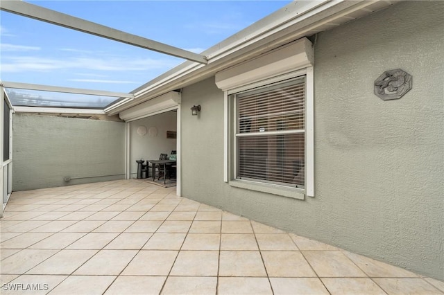 view of patio featuring a lanai