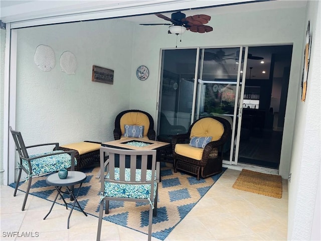 view of patio with a fire pit and a ceiling fan