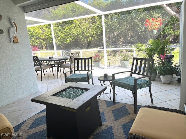 view of patio / terrace with glass enclosure, a fire pit, and outdoor dining space