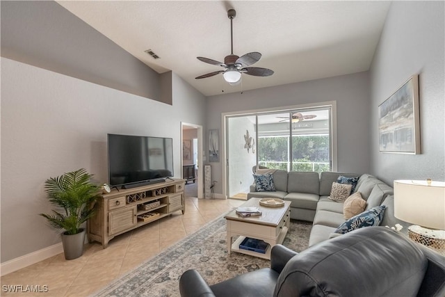 living room with a ceiling fan, lofted ceiling, baseboards, and light tile patterned floors