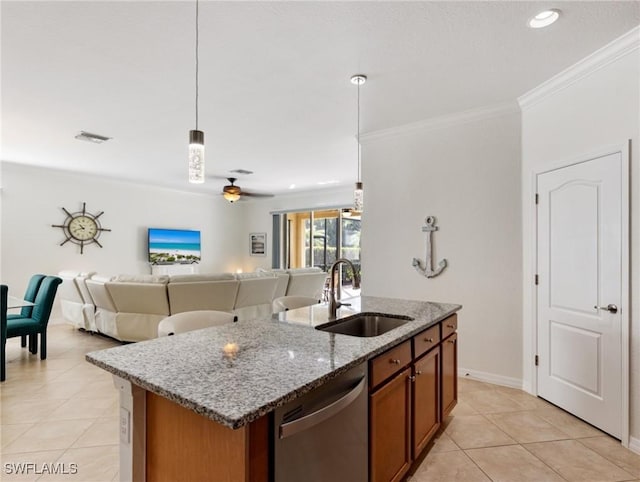 kitchen with a kitchen island with sink, sink, decorative light fixtures, and stainless steel dishwasher