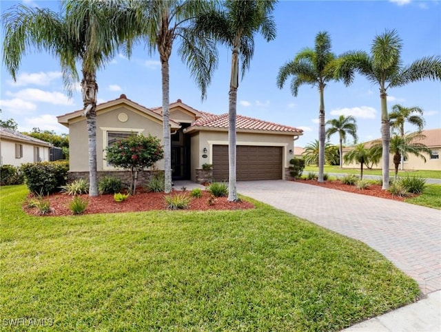 mediterranean / spanish home with a garage and a front lawn