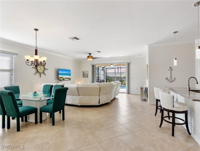 living room with crown molding, ceiling fan, sink, and light tile patterned floors