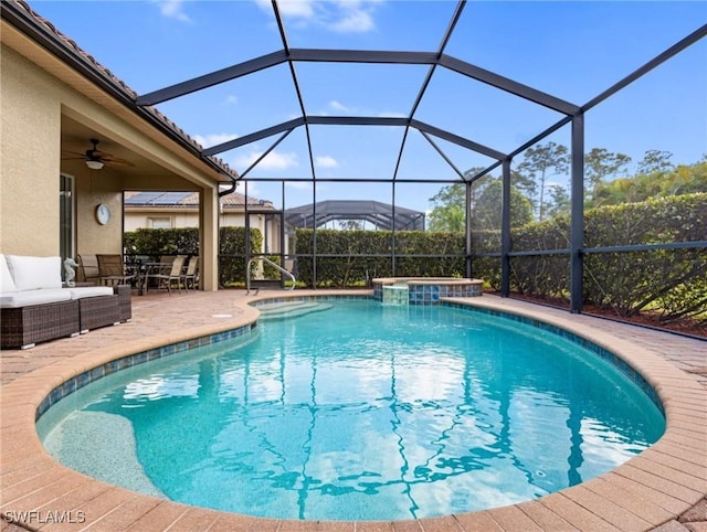 view of pool featuring a patio area, ceiling fan, and glass enclosure