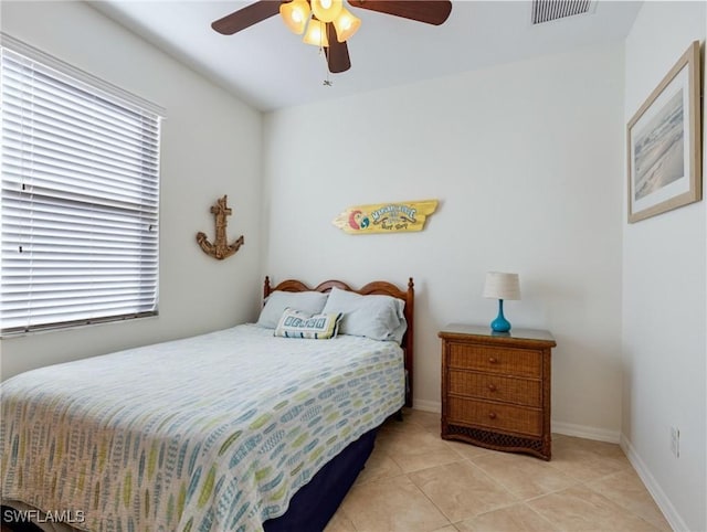 tiled bedroom with multiple windows and ceiling fan