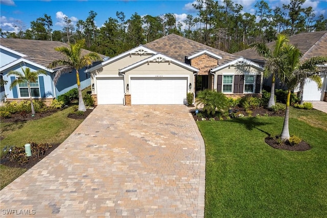 single story home featuring a garage and a front lawn