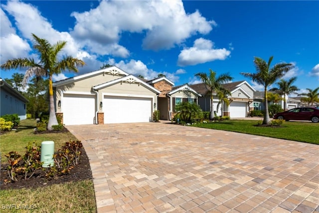 ranch-style house with a garage and a front lawn